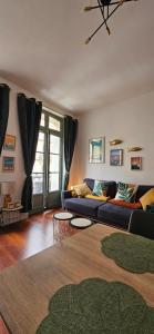a living room with a couch and a table at Les balcons de Dieppe - appartement 1ER étage - certifié 3 étoiles au cœur de la rue piétonne in Dieppe