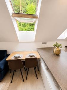 a small kitchen with a table and two chairs at Elysian apartment 1 in Trenčín +23 photos