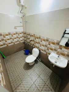 a bathroom with a toilet and a sink at Iconic villas by ROYAL VILLAS in Athirappilly