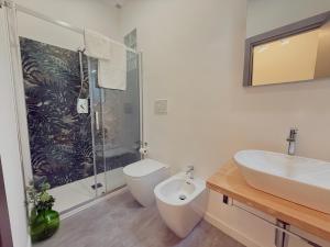 a bathroom with a toilet and a sink and a shower at Taormina Naxos Home 2 in Giardini Naxos +9 photos