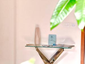 a glass shelf on a wall with books and a vase at Taormina Naxos Home 2 in Giardini Naxos
