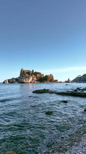 an island in the middle of a body of water at Taormina Naxos Home 2 in Giardini Naxos