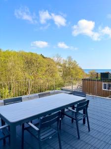 a picnic table with two benches on a patio at 105 beach lodge millendreath in Looe