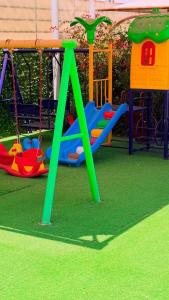 a playground with a play equipment in a park at Labella Chalet in Barka +15 photos