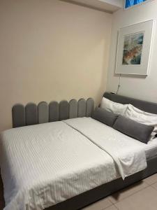a bedroom with a large bed with white sheets at Hra in Loutraki