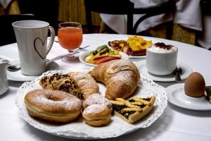 a plate of pastries and bread on a table at Marchi Hotel in Soliera