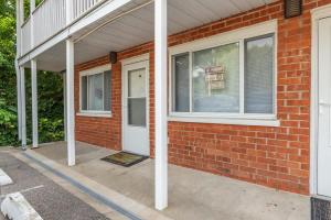 a brick house with a white door and windows at Karma Vibe Like That in Bloomington