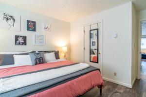 a bedroom with a large bed with a red blanket at Karma Vibe Like That in Bloomington
