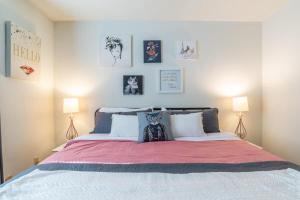 a bedroom with a large bed with two lamps at Karma Vibe Like That in Bloomington +5 photos