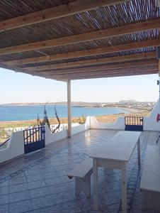 a patio with a table and a view of the ocean at Prasonisi villas in Karpathos