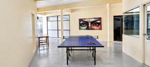 a ping pong table in a room with a painting at Centerpoint Koh Phangan New in Thong Sala