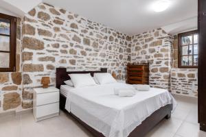 a bedroom with a stone wall and a bed at Casa del Sol in Strp