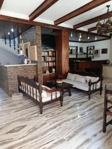 a living room with two benches and a couch at Pegasus Hotel in Pythagoreio
