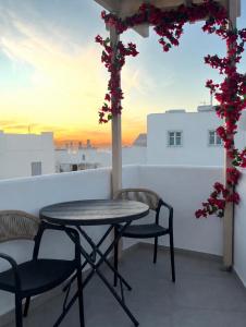 a table and chairs on a balcony with a view at K&M studio in Naxos Chora