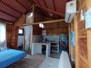 a kitchen and living room in a tiny house at Palmar Beach Cabañas - Bahía Rada in Moñitos +30 photos
