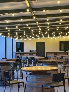 a dining room with tables and chairs and lights at Domaine de cézille-Appart hotel le Moulin du lac in Jayat +13 photos