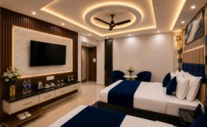 a hotel room with a bed and a flat screen tv at Hotel CIELO PRIME Near Delhi Airport in New Delhi
