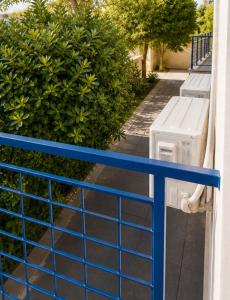 a blue fence with a bench in front of a bush at Luxury hideaway in Larnaca