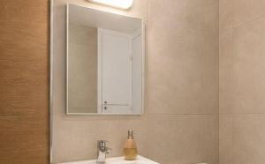 a bathroom with a sink and a mirror at Luxury hideaway in Larnaca