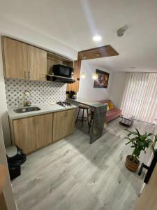 a kitchen with a sink and a table in a room at Apartaestudio vacacional in Armenia +7 photos