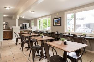 a row of tables and chairs in a restaurant at Bar Harbor Villager Motel - Downtown in Bar Harbor