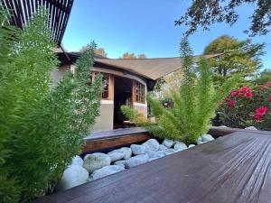 a house with a wooden table and some plants at Pumula Luxury Camps in Lions River