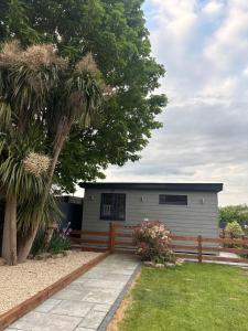a house with a fence in a yard at Riverside Lodge in Creech Saint Michael