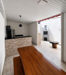 a living room with a table and a fireplace at Casa no Centro de Prado in Prado