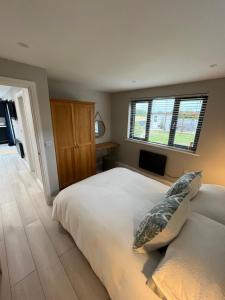 a bedroom with a large bed and a window at Riverside Lodge in Creech Saint Michael +9 photos