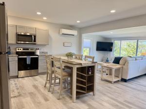 a kitchen and living room with a table and a couch at Oceanfront Cottage on Private Island in Milbridge