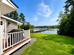 a porch of a house with a view of a lake at Oceanfront Cottage on Private Island in Milbridge
