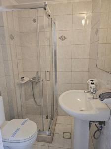 a bathroom with a shower and a toilet and a sink at Amfitrion on the Town in Gythio +40 photos