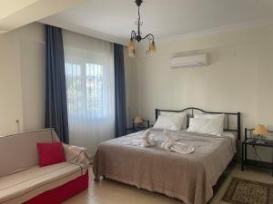 a bedroom with a bed and a couch in it at Villa Mango in Fethiye +36 photos