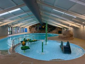 a large indoor swimming pool with a water slide at Seaside Escape in St Ives
