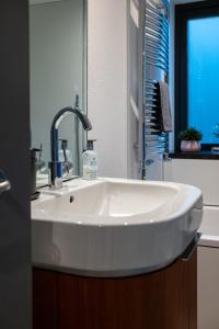 a white sink in a bathroom with a mirror at The Seahorse Torbay in Torquay +34 photos