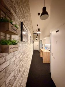 a hallway of a office with a brick wall at Royal Aparthotel Piotrkowska 116 in Łódź