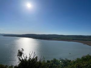a large body of water with the sun in the sky at Vanellus in Balatongyörök
