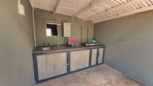 a kitchen with a counter and a sink in a room at Zuri Camp - Tent Kiama in Tsumeb