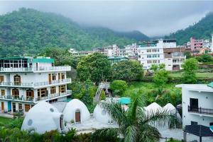 a city with white buildings and a mountain at Boho Stays Rishikesh in Rishīkesh