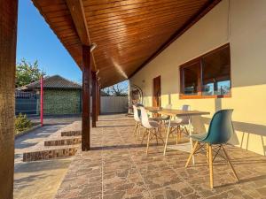 a patio with a table and chairs on it at Casa Maia Corbu in Corbu