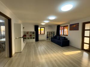 a living room with a blue couch and a table at Casa Maia Corbu in Corbu