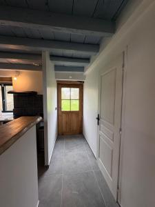 a hallway with a door leading to a kitchen at 9 La Roche La Bergerie in Saint-Plantaire +7 photos