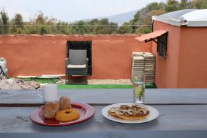 a table with two plates of food and a glass at House antigua Guatemala in Antigua Guatemala