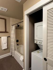 a bathroom with a tub and a shower and a sink at 3rd Street Flats in McMinnville +105 photos