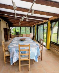 a dining room with a table and chairs at Escapade bucolique calme et nature in Saint-Léger-aux-Bois