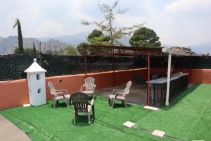 a yard with chairs and a table and a bird house at House antigua Guatemala in Antigua Guatemala
