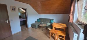 a living room with a couch and a table at Guesthouse Mirko Hodak in Seliste Dreznicko