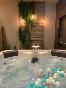 a jacuzzi tub with a bunch of balloons in it at The Party Hub in Boston