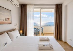 a bedroom with a bed with a view of the ocean at DoR Stay Seaside in Durrës