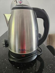 a tea kettle sitting on top of a stove at Kaz a kann là in Petit-Canal